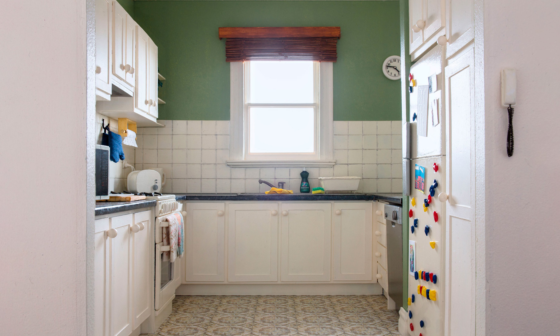 A scale model of a miniature suburban kitchen.