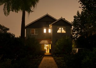 A large square house photographed at night.