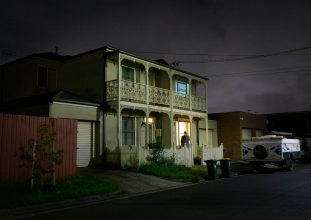 A terrace house photographed at night.